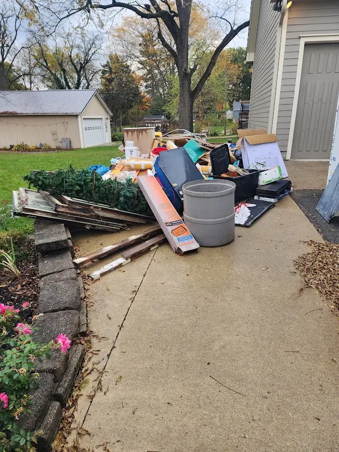 Dumpster being loaded with debris for 12 Yard Dumpster Rental in Dogtown
